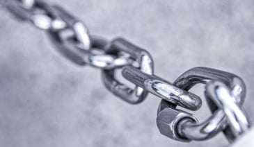 3 grey metal chain links on grey background