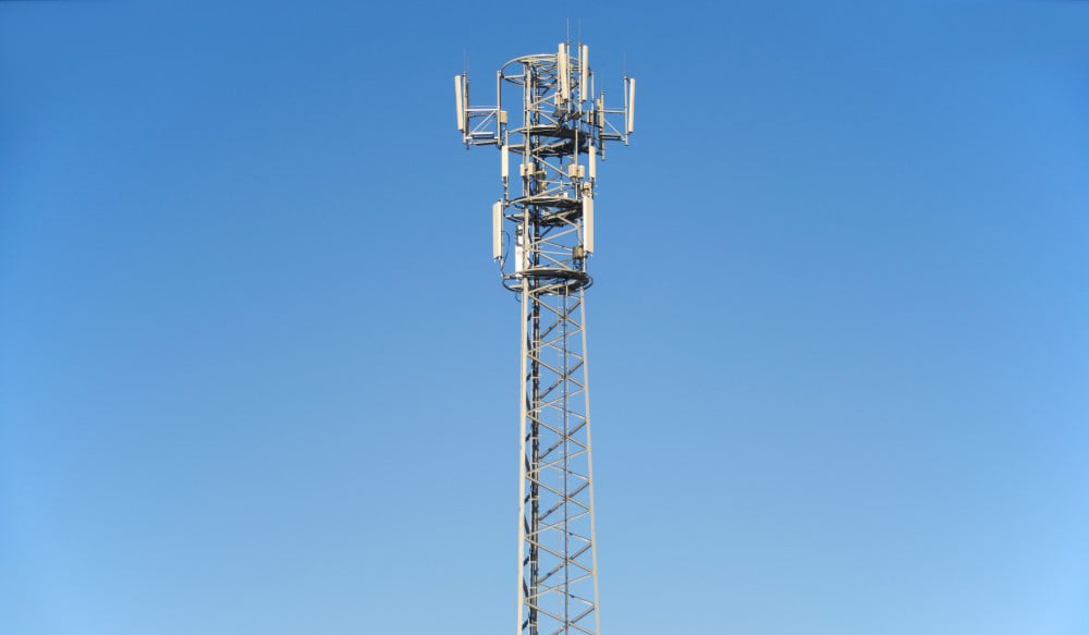 Tall telecommunications tower and clear blue sky