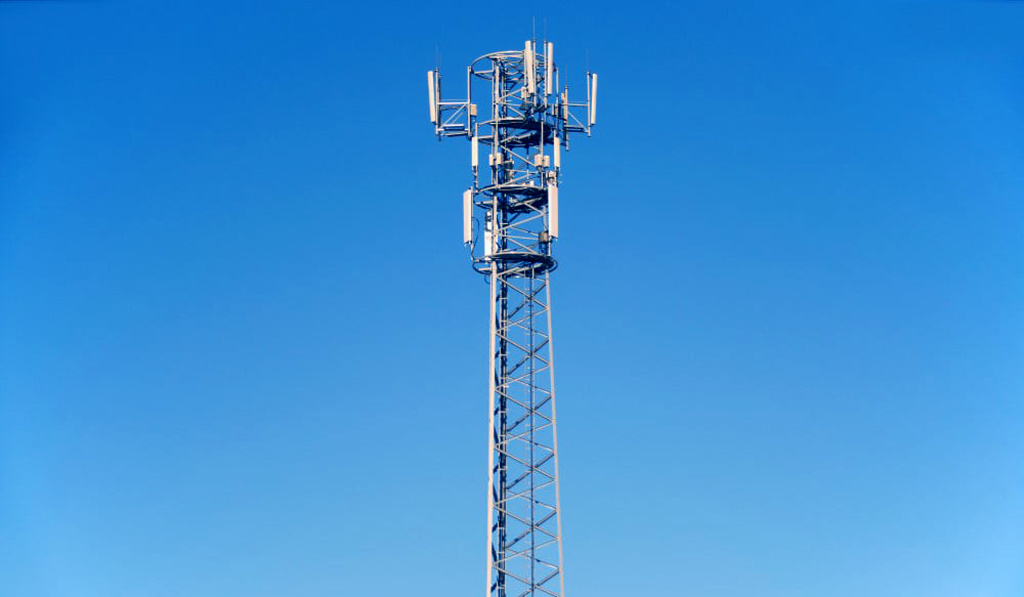 Tall telecommunications tower and clear blue sky