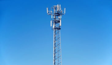 Tall telecommunications tower and clear blue sky